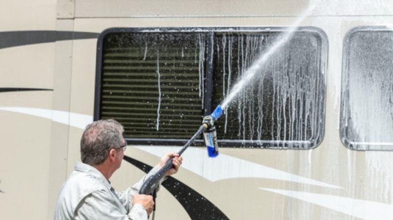 Man using Ryobi Foam Blaster on car