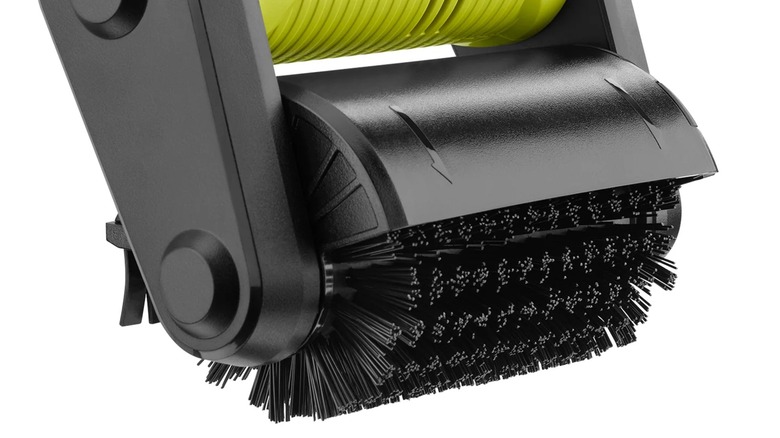 A close-up of a Ryobi patio cleaner brush.