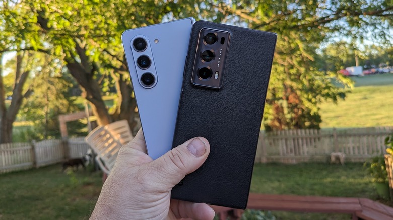 Man holding two phones