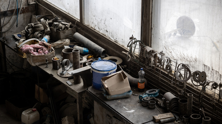 Overhead photo of a dirty and cluttered workbench