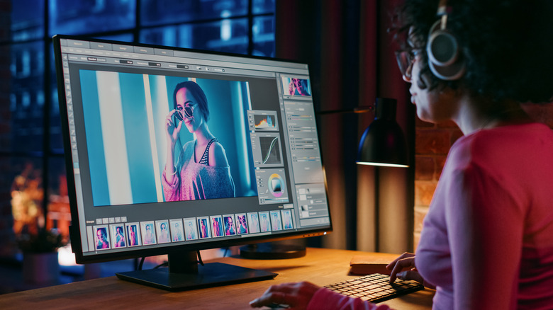 Person wearing headphones while using Photoshop