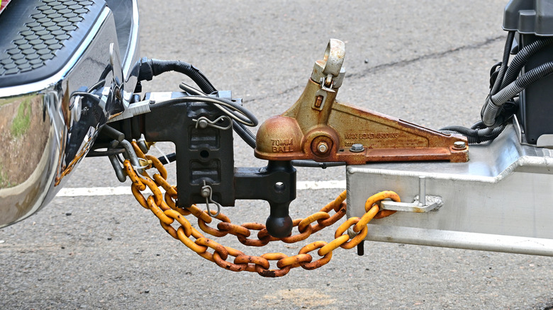 A towing hitch with safety chains attached.