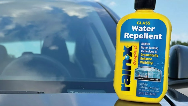 A bottle of Rain-X glass water repellent on a car.