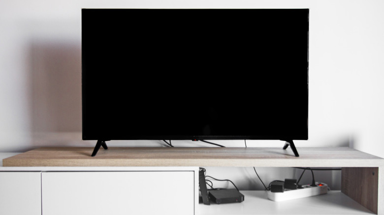 A TV plugged into a power strip.