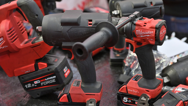 Several Milwaukee power tools on a work bench