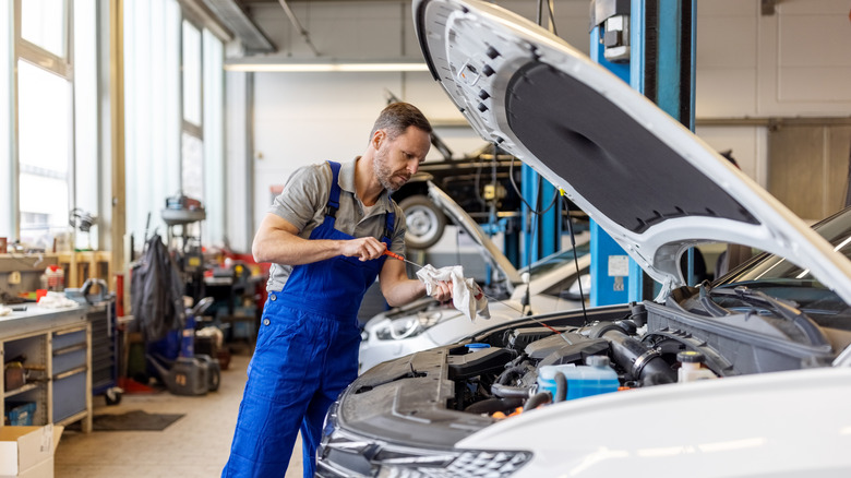 Man changing vehicle oil