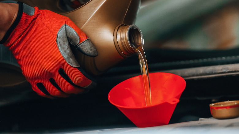 Oil being poured into vehicle