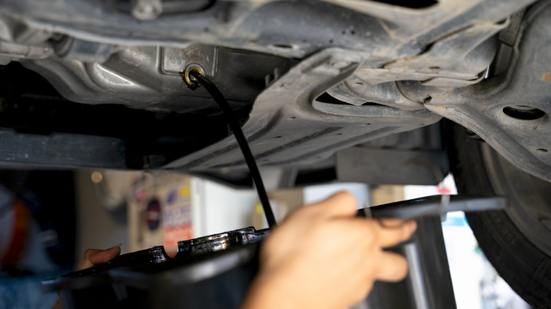 Car's oil being changed