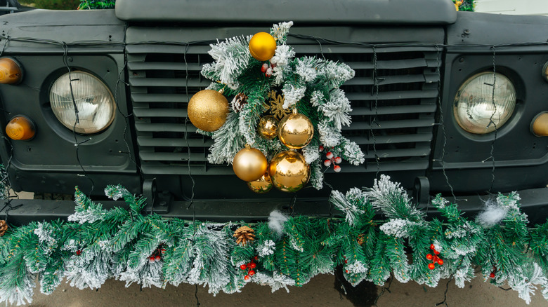 Holiday wreath and garland on car grille and bumper