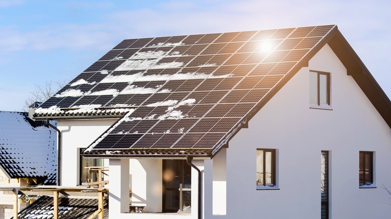 Snow melting on solar panels in winter