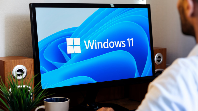 Man working on computer with Microsoft Windows