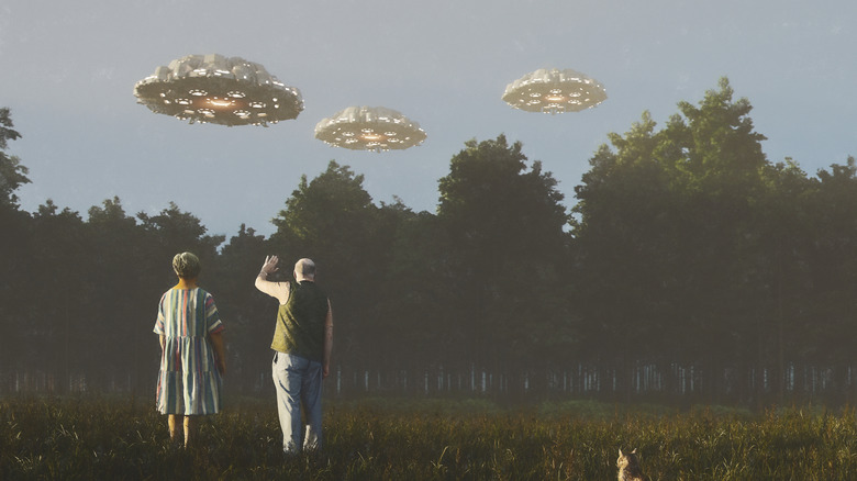 senior couple waving at ufos