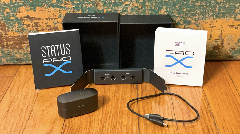 Status Pro X packaging, charging case, charging cable, and alternate tips.