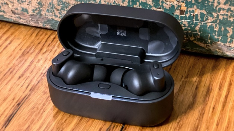 Closeup of the Status Pro X earbuds in a person's left ear.