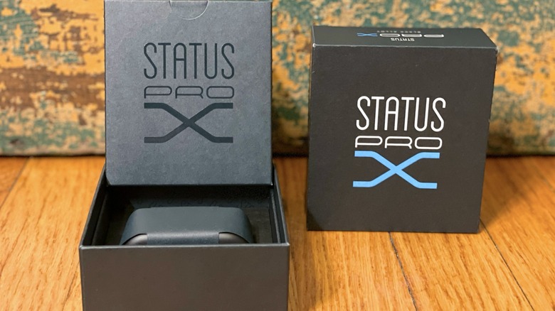Open Status Pro X packaging with the buds and charging case tucked inside.