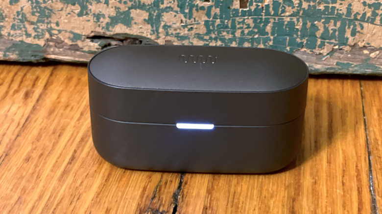 Closed Status Pro X charging case with the battery light glowing white.