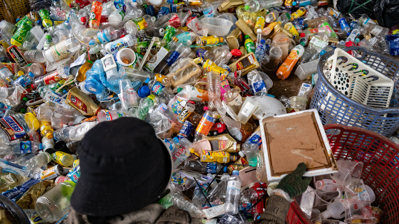 A person sorting through plastic waste