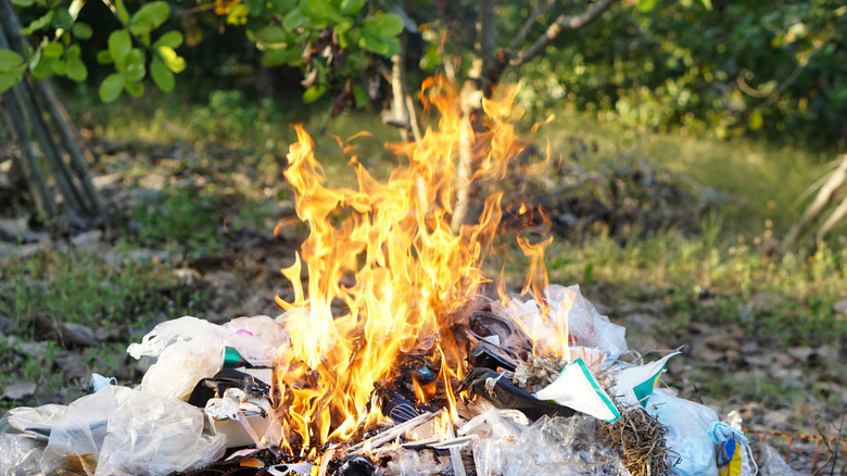 A burning pile of garbage and plastic waste