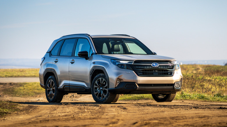 A beige Subaru Forester on a dirt road
