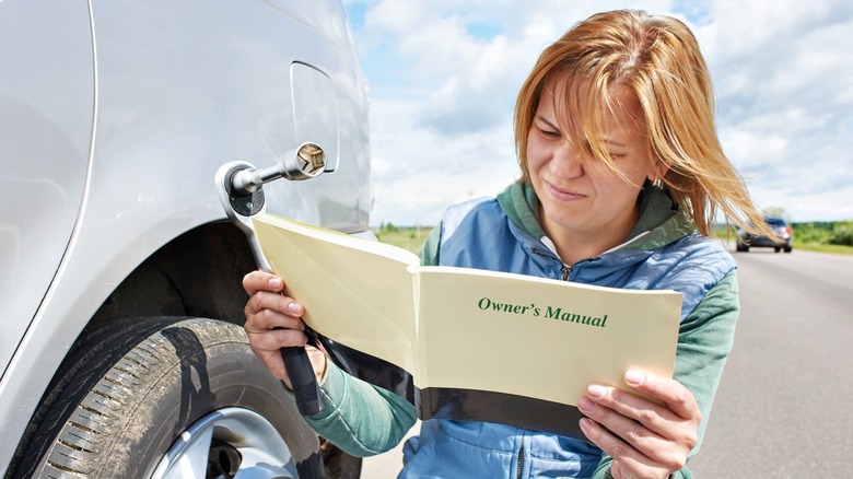 Woman reading owner's manual