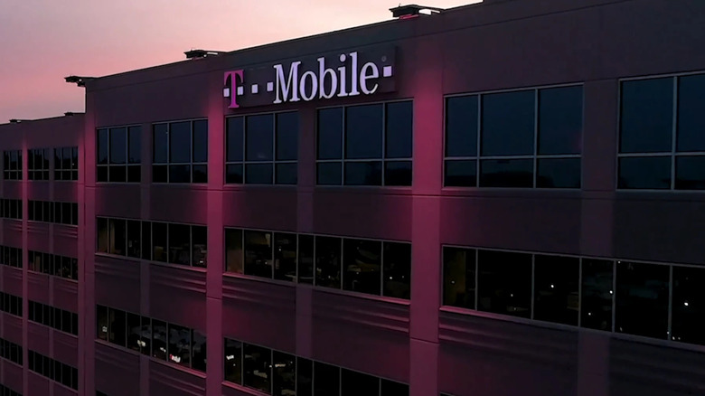 A large building with a large lit T-Mobile logo sign on the front