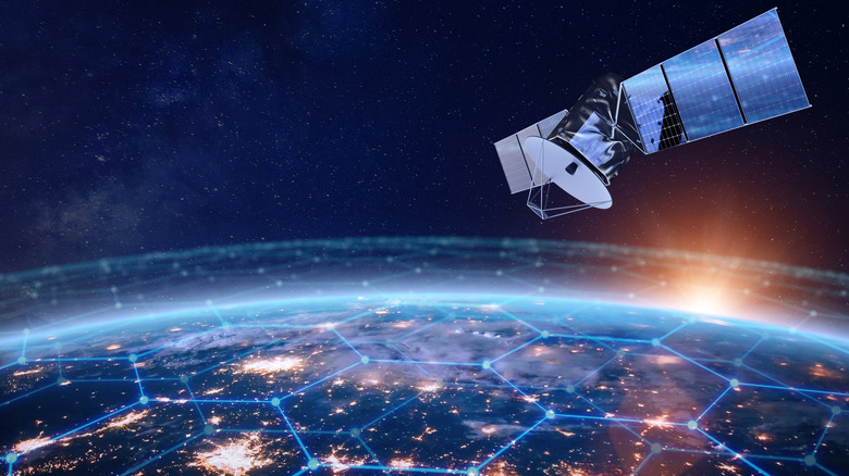 Telecommunication satellite above Earth with illustration of cell service on planet