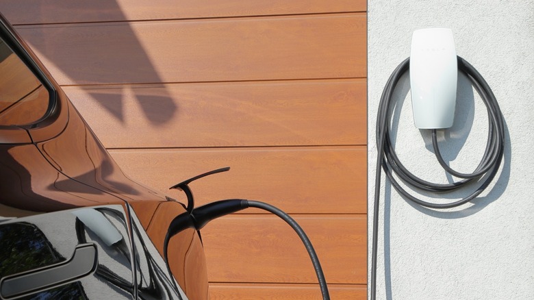 A Tesla plugged into a home charger