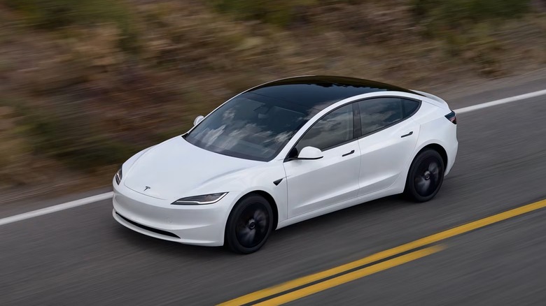 Tesla Model 3 Standard Edition driving on road, front-left view from height