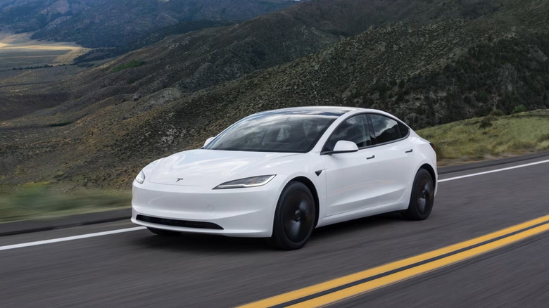 Tesla Model 3 Standard Edition driving on mountain road, front-left view