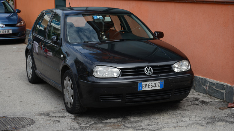 A black Mk4 Volkswagen Golf, front 3/4 view