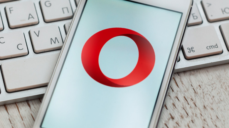 Opera on an iPhone, laying on an Apple keyboard