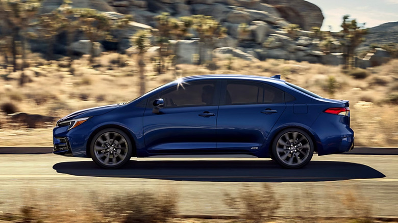 A blue Toyota Corolla on a desert highway