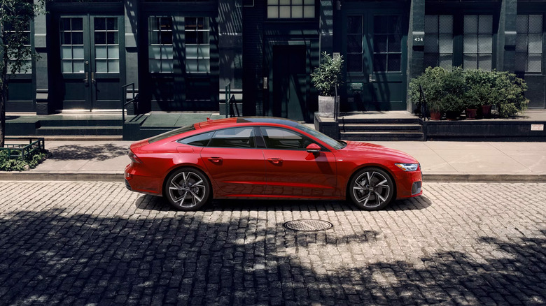 A red Audi A7 parked on a city street