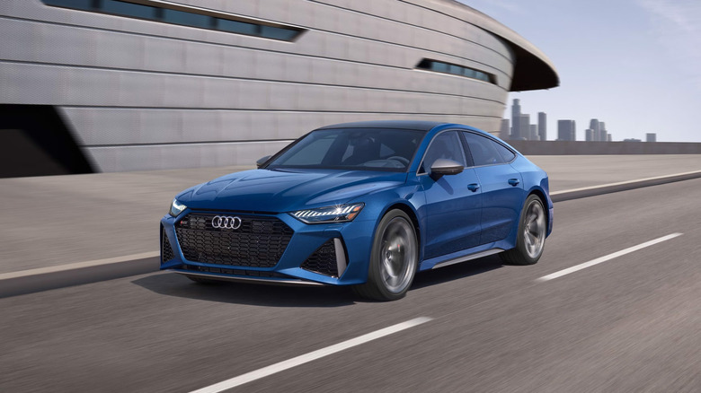 A blue Audi RS7 driving on a highway