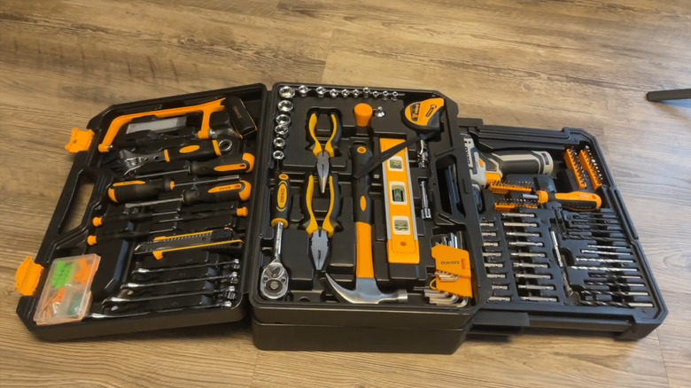 open Dekopro black plastic toolbox with yellow and black tools inside