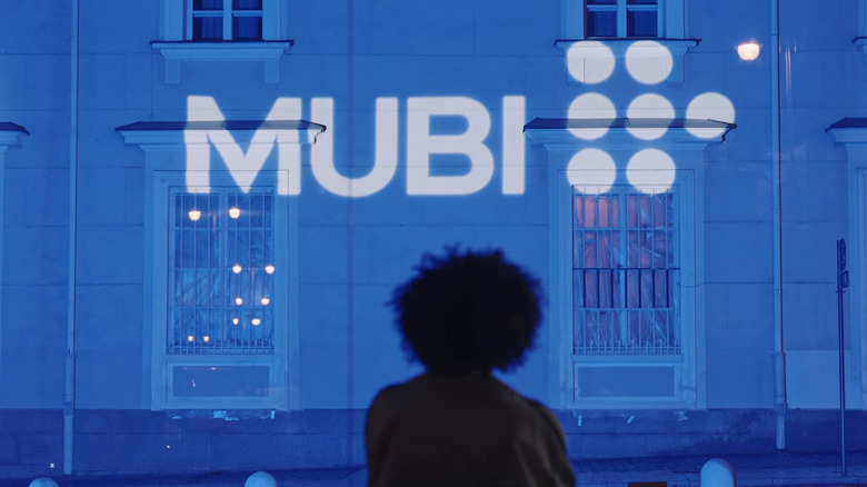 Woman looking up at Mubi logo