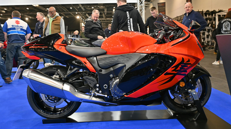An orange Suzuki Hayabusa on display indoors at a motor show