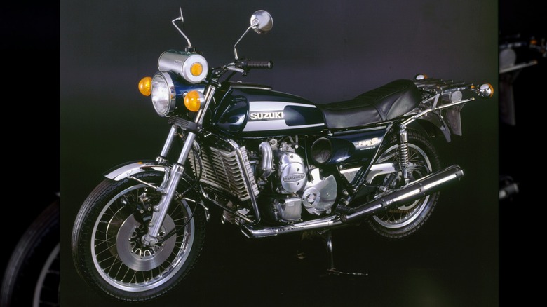 A black Suzuki RE 5 in a black-background studio.