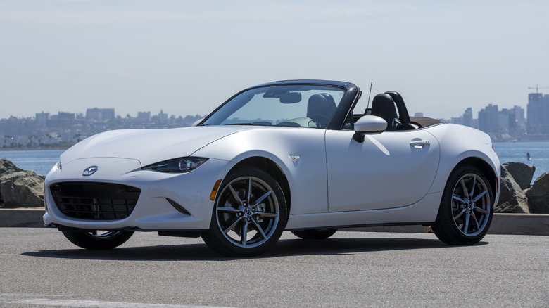 White Mazda MX-5 Miata seen from front and side angle