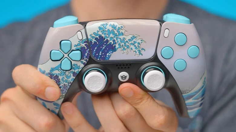 A person holding a custom HexGaming PS5 controller.