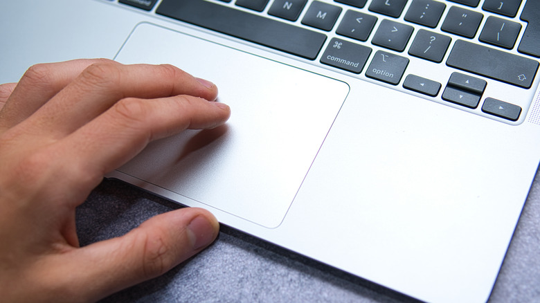 Man clicking a trackpad. 