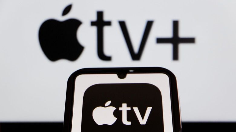 Apple TV+ and Apple TV on a phone screen and in the background