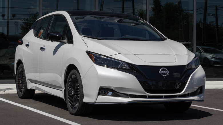 White Nissan Leaf sitting at a dealership