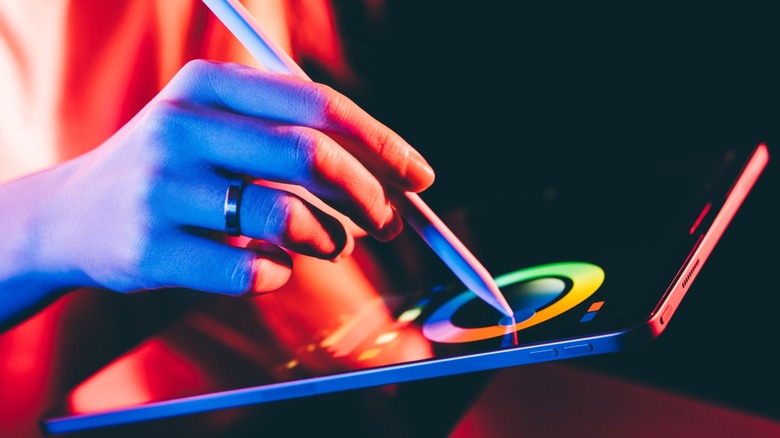 Person using a stylus on an iPad