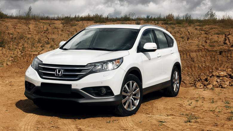 A white Honda CR-V on a dirt path