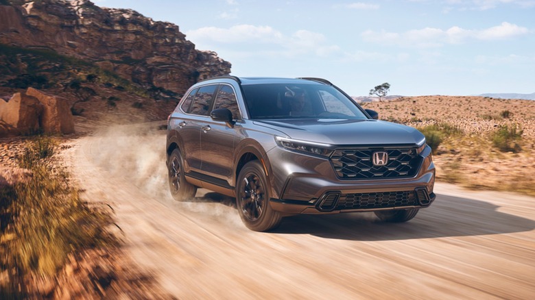 A Honda CR-V driving on a dirt road