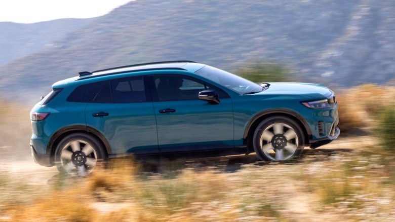 A Honda Prologue driving up a hill