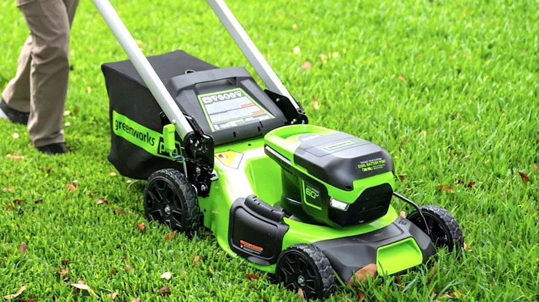 Person pushing Greenworks lawnmower