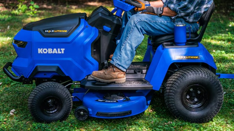 A person riding a Kobalt lawn mower