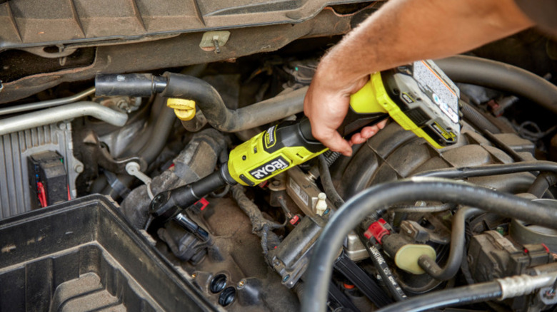 Ryobi HP Brushless 3/8" Extended Reach Ratchet being used on car engine